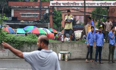 হাতে প্লাস্টার নিয়ে রাস্তা পার হতে রোড ডিভাইডারে উঠেছেন একজন রোগী