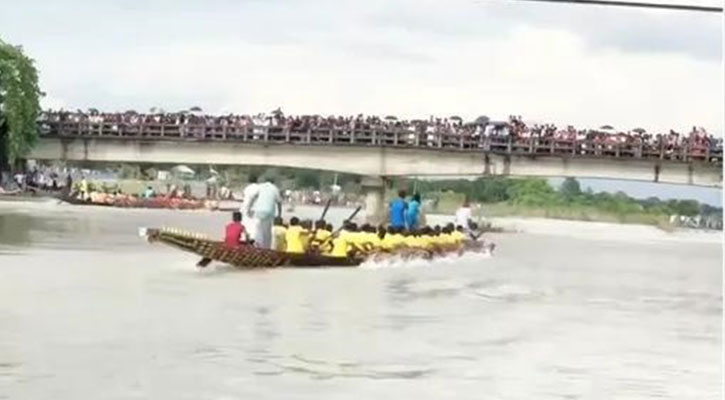 নৌকা বাইচ দেখতে হাজারো মানুষের ভিড়